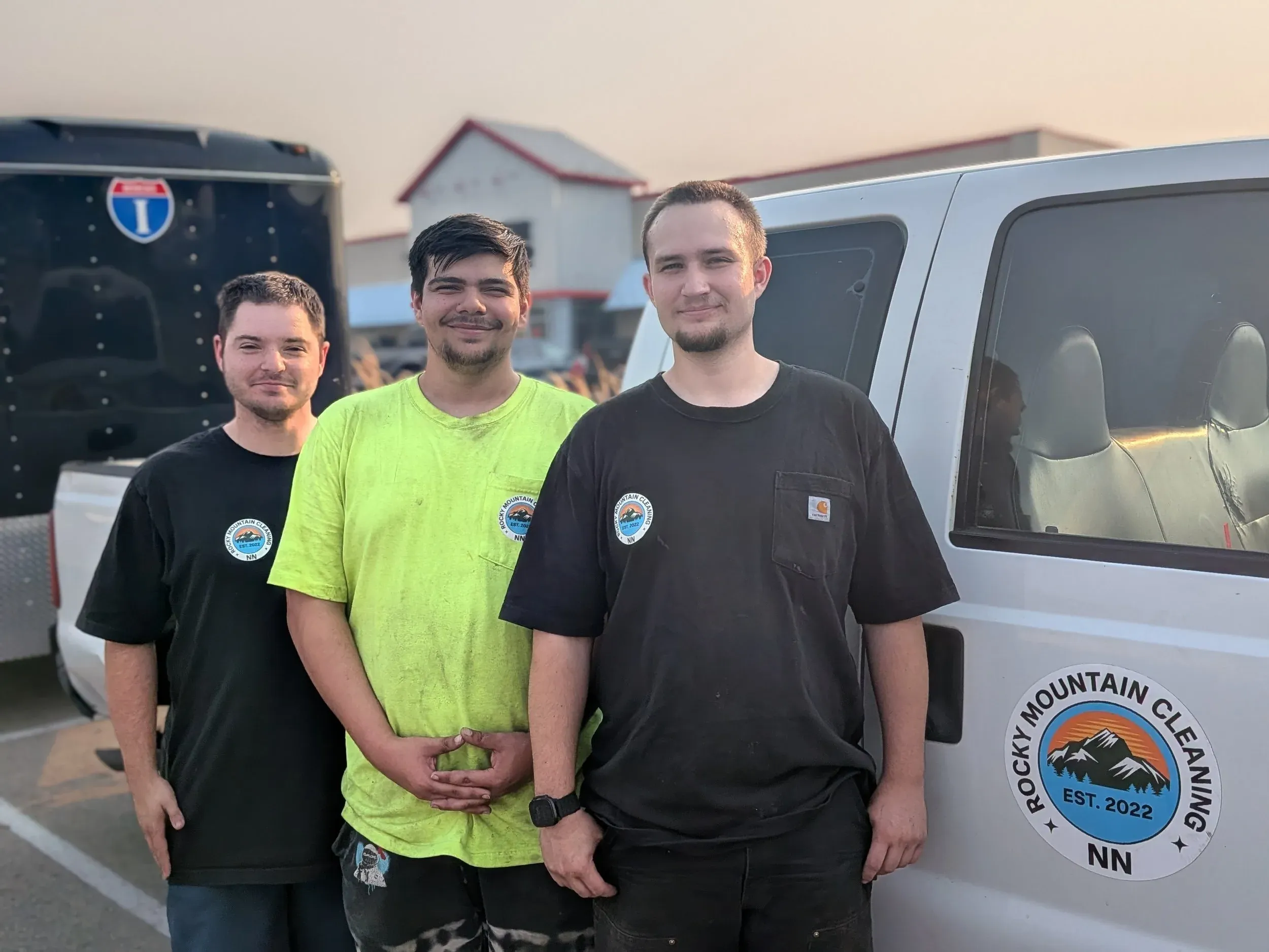 The Rocky Mountain Cleaning Services crew in Boise, standing with their logo-badged work vehicle.